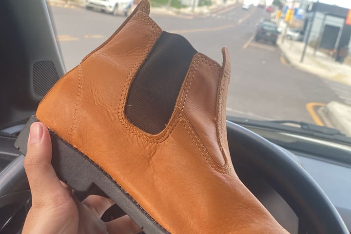 A tan leather boot from the range I sourced, held up in the car.
