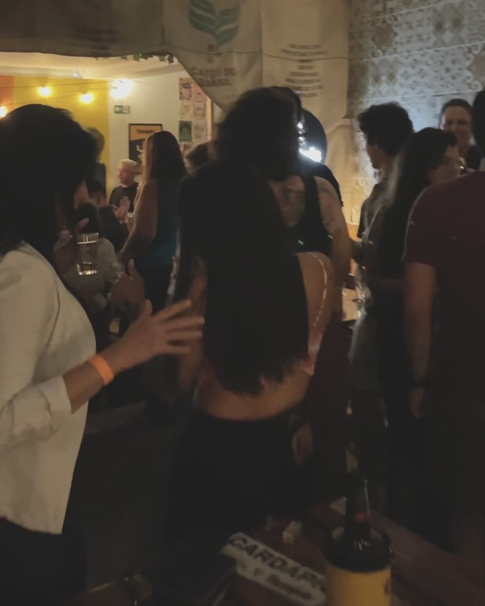 The room full of customers standing and talking during an evening service.